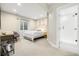 Serene bedroom with white linens, a desk, and an adjacent glass-enclosed shower at 800 Meadowlark Dr, Erie, CO 80516