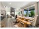 Dining room with a wooden table and bench seating, with a large glass sliding door to the porch at 800 Meadowlark Dr, Erie, CO 80516