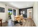 Dining room with cow hide rug under a wooden table and bench seating, along with a large sliding glass door at 800 Meadowlark Dr, Erie, CO 80516