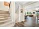 Inviting foyer showcasing staircase and an open-concept floorplan leading to the living and kitchen areas at 800 Meadowlark Dr, Erie, CO 80516