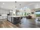 Open-concept kitchen boasts a spacious island with seating and pendant lighting, perfect for entertaining at 800 Meadowlark Dr, Erie, CO 80516