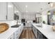 Modern kitchen with stainless steel appliances, white countertops, subway tile backsplash, and center island at 800 Meadowlark Dr, Erie, CO 80516