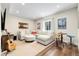 Spacious living room with a large sectional sofa, round ottoman, and stylish decor at 800 Meadowlark Dr, Erie, CO 80516