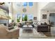 The open living room has a fireplace and large windows with outside views that fill the room with natural light at 800 Meadowlark Dr, Erie, CO 80516