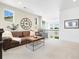 Inviting living room boasts a leather sofa, chair, and large decorative clock at 800 Meadowlark Dr, Erie, CO 80516