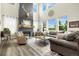 Bright living room features a cozy fireplace, high ceilings, and large windows offering picturesque views at 800 Meadowlark Dr, Erie, CO 80516