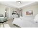 Main bedroom showcases neutral tones, dresser, ceiling fan, and ensuite access at 800 Meadowlark Dr, Erie, CO 80516