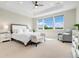 Bright main bedroom with large windows and sitting area; ceiling fan at 800 Meadowlark Dr, Erie, CO 80516
