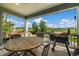 Covered patio with round table and a Traeger grill, perfect for outdoor dining with an open field view at 800 Meadowlark Dr, Erie, CO 80516