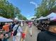 Charming community event with vendors and visitors on a tree-lined street at 800 Meadowlark Dr, Erie, CO 80516