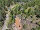 Aerial view of a charming house surrounded by dense woods, revealing its private setting at 11220 S Deer Creek Rd, Littleton, CO 80127