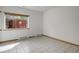 Clean bedroom with tile flooring, a window with backyard view, and baseboard heating at 11220 S Deer Creek Rd, Littleton, CO 80127
