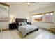 Bright bedroom featuring neutral decor, a ceiling fan, and large windows providing ample natural light at 11220 S Deer Creek Rd, Littleton, CO 80127