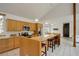 Bright kitchen features a breakfast bar with seating and stainless steel appliances at 11220 S Deer Creek Rd, Littleton, CO 80127