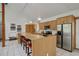 Bright kitchen features a breakfast bar with seating and stainless steel appliances at 11220 S Deer Creek Rd, Littleton, CO 80127