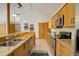 Bright kitchen featuring a breakfast bar with seating, stainless steel appliances, and tile flooring at 11220 S Deer Creek Rd, Littleton, CO 80127