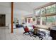 Inviting living room featuring large windows and a wood burning fireplace at 11220 S Deer Creek Rd, Littleton, CO 80127