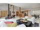Open living space featuring high ceilings and seamless flow between living room, dining, and kitchen at 11220 S Deer Creek Rd, Littleton, CO 80127