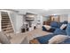 Finished basement with neutral carpet, blue sofas, and TV at 6671 Chase St, Arvada, CO 80003