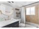 Modern bathroom with new vanity, round mirror and tiled shower at 6671 Chase St, Arvada, CO 80003