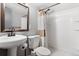 Bathroom featuring a pedestal sink, toilet, shower and stylish accents at 6671 Chase St, Arvada, CO 80003