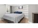 Comfortable bedroom with a striped accent wall, carpet flooring and a bright window at 6671 Chase St, Arvada, CO 80003