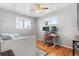 Bright bedroom with hardwood floors, two windows, and a ceiling fan at 6671 Chase St, Arvada, CO 80003