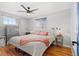 Bright bedroom features wood floors, a ceiling fan, and natural light at 6671 Chase St, Arvada, CO 80003