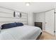 Neutral bedroom featuring a light fixture and white doors, complimented by a cozy atmosphere at 6671 Chase St, Arvada, CO 80003