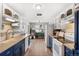 Kitchen with white cabinetry and blue accents, complete with modern appliances at 6671 Chase St, Arvada, CO 80003
