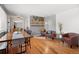 Spacious living room featuring hardwood floors, exposed brick, and open layout at 6671 Chase St, Arvada, CO 80003