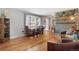 Inviting living room features hardwood floors, modern decor, and a decorative brick wall at 6671 Chase St, Arvada, CO 80003
