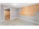 Unfinished room adjacent to a room with carpet flooring, ready for customization at 6671 Chase St, Arvada, CO 80003
