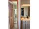 Bathroom view featuring a step-in shower with glass doors and tile surround at 6836 W 84Th Cir # 15, Arvada, CO 80003