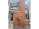 Two-story townhome with brick facade, modern windows, and storm door at 6836 W 84Th Cir # 15, Arvada, CO 80003