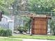 Charming wooden garden gate entrance, landscaped with lush plants and serene garden views at 6836 W 84Th Cir # 15, Arvada, CO 80003