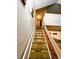Staircase with neutral carpet and wood railing leading to upper level at 6836 W 84Th Cir # 15, Arvada, CO 80003