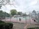 Outdoor tennis court featuring well-maintained surface and community gray buildings at 6836 W 84Th Cir # 15, Arvada, CO 80003