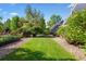 Backyard with a lush lawn and manicured landscaping at 3330 E Tennessee Ave, Denver, CO 80209