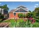 Backyard with lush landscaping, manicured lawn, and blooming purple flowers for added curb appeal at 3330 E Tennessee Ave, Denver, CO 80209