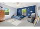 Cozy bedroom with blue accent wall, comfortable seating, and lots of natural light at 3330 E Tennessee Ave, Denver, CO 80209