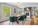 Open dining room with hardwood floors, fireplace, and modern decor at 3330 E Tennessee Ave, Denver, CO 80209