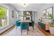 A dining room features a large table and chairs, built-in shelving, and a decorative fireplace at 3330 E Tennessee Ave, Denver, CO 80209