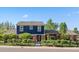 Charming two-story home with a beautiful blue and brick facade, surrounded by a well-manicured lawn at 3330 E Tennessee Ave, Denver, CO 80209
