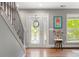 Inviting foyer featuring hardwood floors, stylish staircase, and decorative glass front door at 3330 E Tennessee Ave, Denver, CO 80209