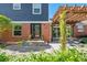Inviting two-story home with a brick facade and a charming pergola-covered patio at 3330 E Tennessee Ave, Denver, CO 80209