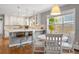 Bright eat-in kitchen boasts white cabinetry, stone countertops, and a charming breakfast nook at 3330 E Tennessee Ave, Denver, CO 80209