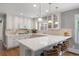 Bright kitchen featuring quartz countertops, stylish cabinetry, and barstool seating at 3330 E Tennessee Ave, Denver, CO 80209