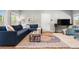 Comfortable living room with plush seating, stylish rug, and plenty of natural light at 3330 E Tennessee Ave, Denver, CO 80209