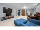 Finished basement living area with cozy seating and a large flatscreen television for entertainment at 3330 E Tennessee Ave, Denver, CO 80209